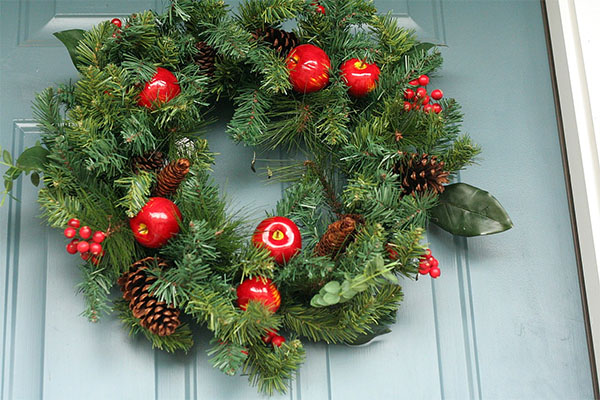 a christmas wreath containing pinecones as a symbol of everlasting life 