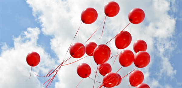 red balloons floating away